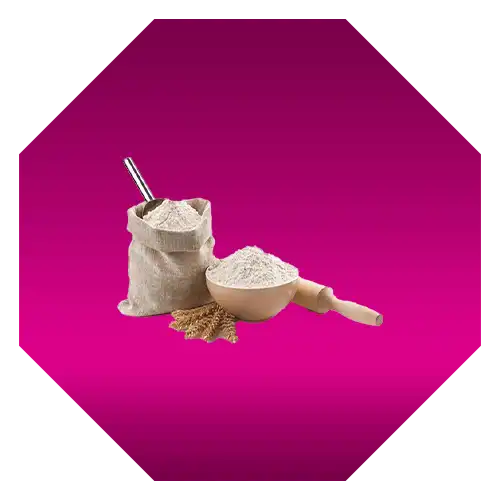 A canvas bag of flour with a metal scoop and wheat grains on a pink background.